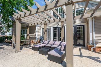 A patio with a couch and a pergola.at Riverview Landing @ Valley Forge, Pennsylvania